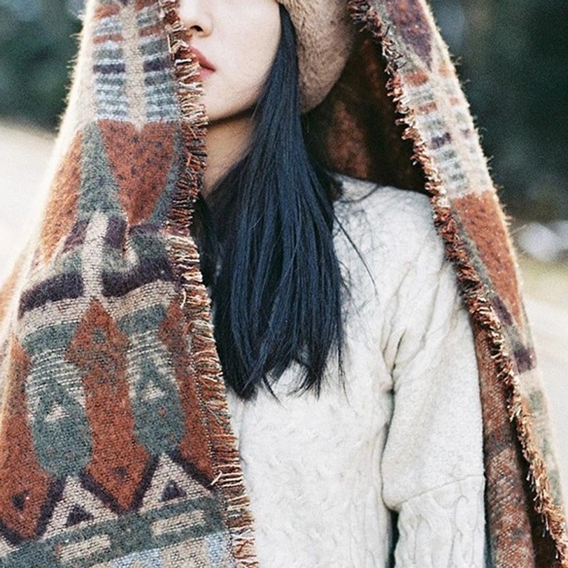 Tibetan geometric woven scarf with frayed raw hem, mixed earthy colorway and detailed textile weave pattern, close-up side face view