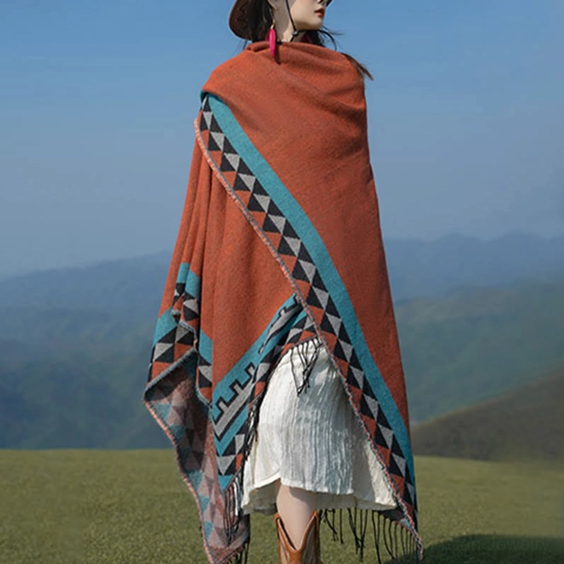 Back right three-quarter view of geometric trim tassel shawl featuring diagonal patterns, terracotta base, and decorative tassel hem