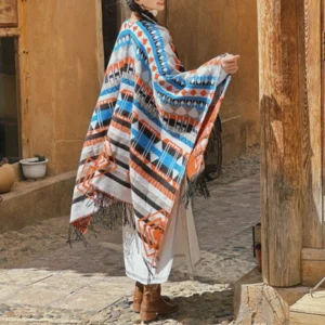 Tibetan geometric tassel shawl worn as bohemian wrap, rear view showing tribal patterns and fringe trim in blue-gray ethnic design