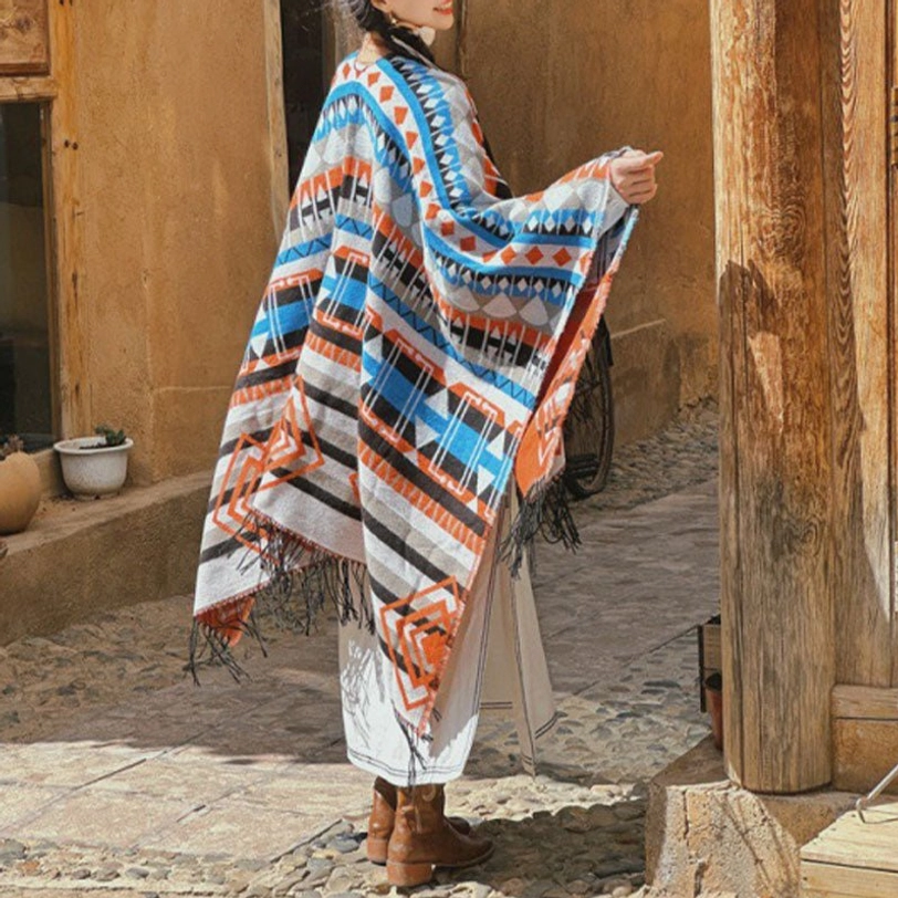 Tibetan geometric tassel shawl worn as bohemian wrap, rear view showing tribal patterns and fringe trim in blue-gray ethnic design