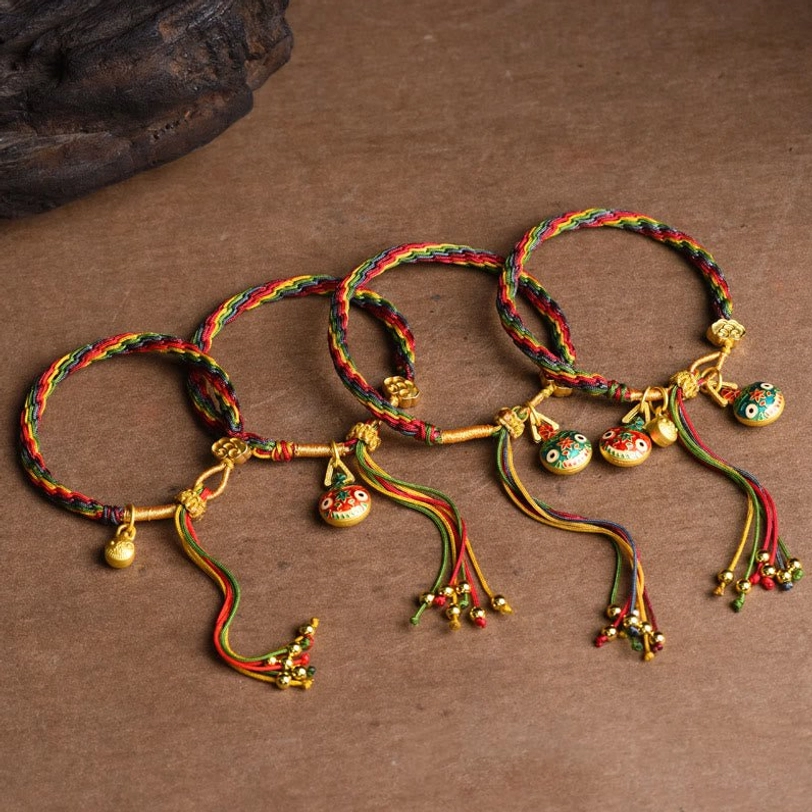 Tibetan gold swallowing beast bracelet multicolor woven cord with enamel beast charm and decorative gold beaded tassel