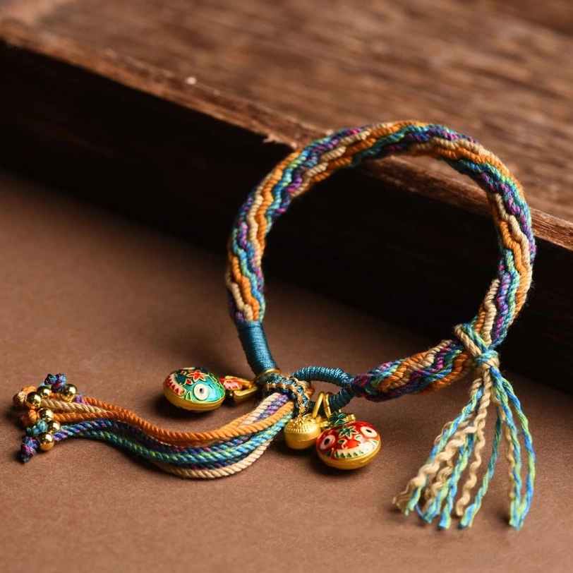 Tibetan gold beast family blessing bracelet featuring reincarnation knot symbolism and handwoven sacred geometry