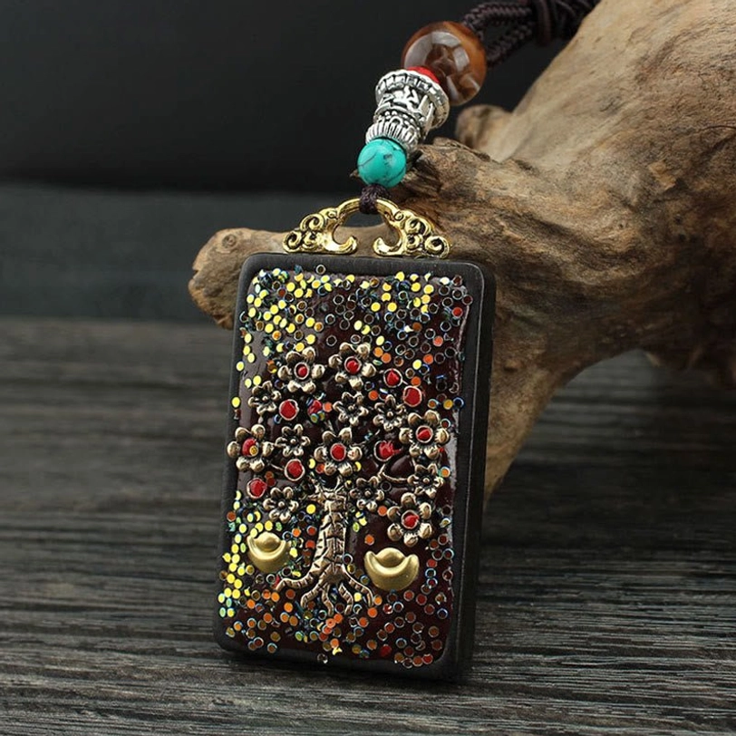Golden Phoenix Tibetan thangka pendant necklace featuring rebirth and transformation symbolism with intricate gold and enamel work