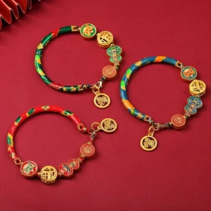 Tibetan gourd prosperity bracelets in multiple colors - red, blue, green, pink - with copper lion charms and fortune pendants on red background