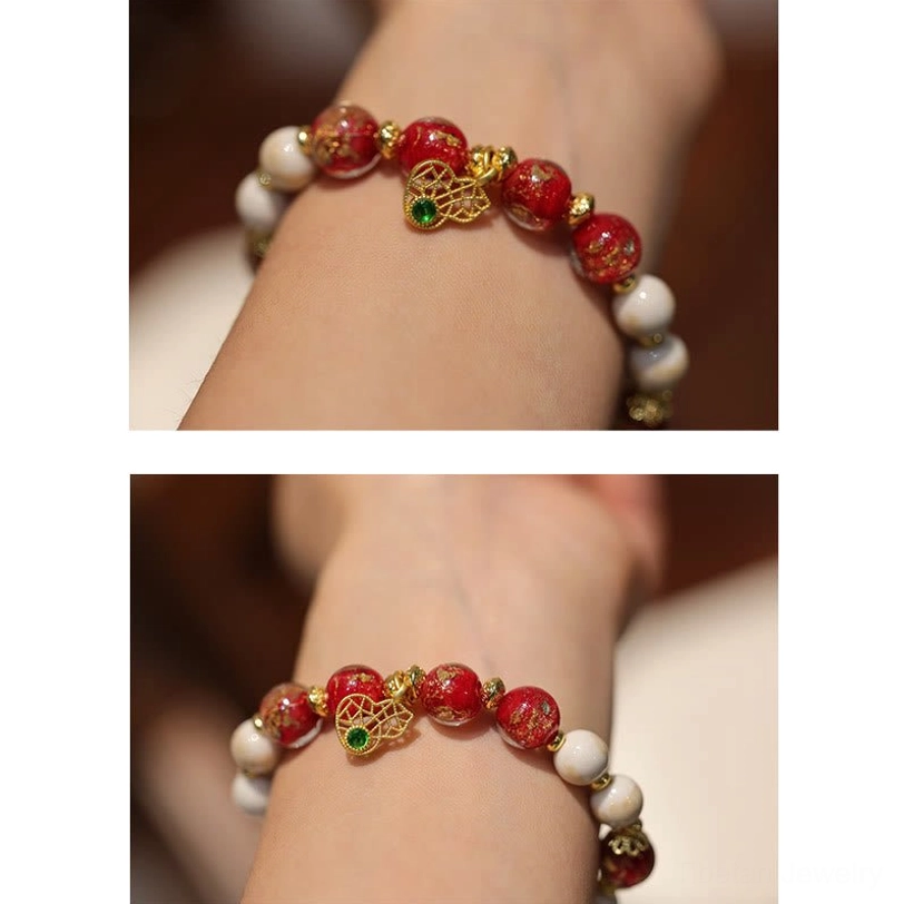 Tibetan god of wealth charm bracelet worn on wrist featuring slim bead design with small pendant, lifestyle wrist wear angle
