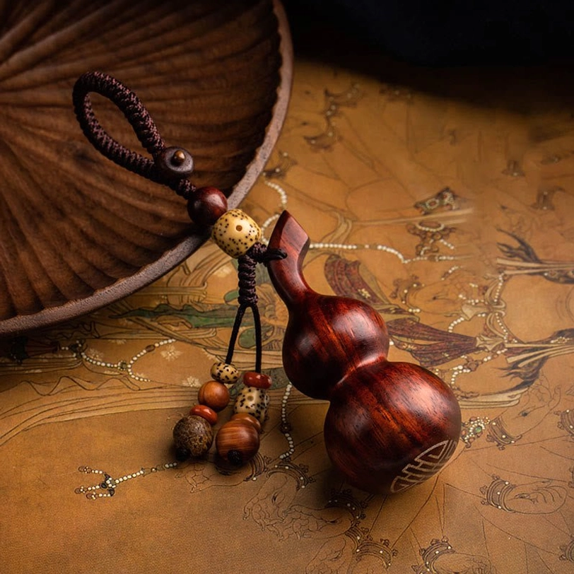 Close-up top view of gourd keychain with full display of mixed wooden bead tassel on kraft paper surface, showcasing fine detail and natural wood color variation