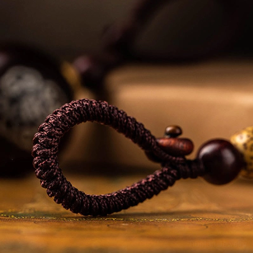 Premium handmade tibetan gourd keychain displaying fine artisan woodwork and natural protective spiritual energy stone bead ornament detail