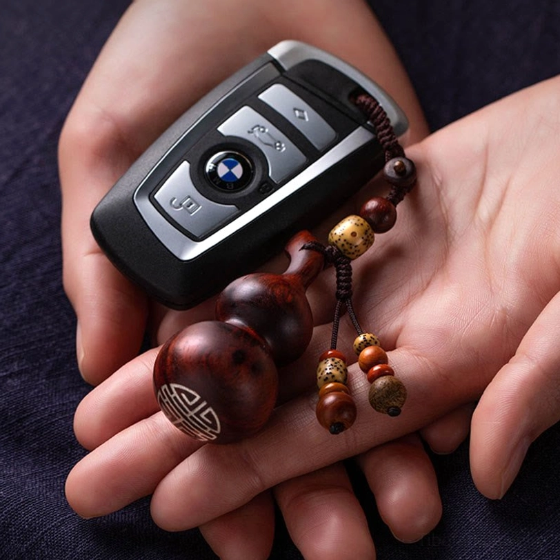 Handcrafted tibetan gourd keychain showcasing traditional carving technique and natural ebony or sandalwood wood grain for spiritual daily practice
