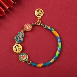 Teal enamel Tibetan gourd prosperity bracelet with gold fortune charms and decorative beads, flat lay view