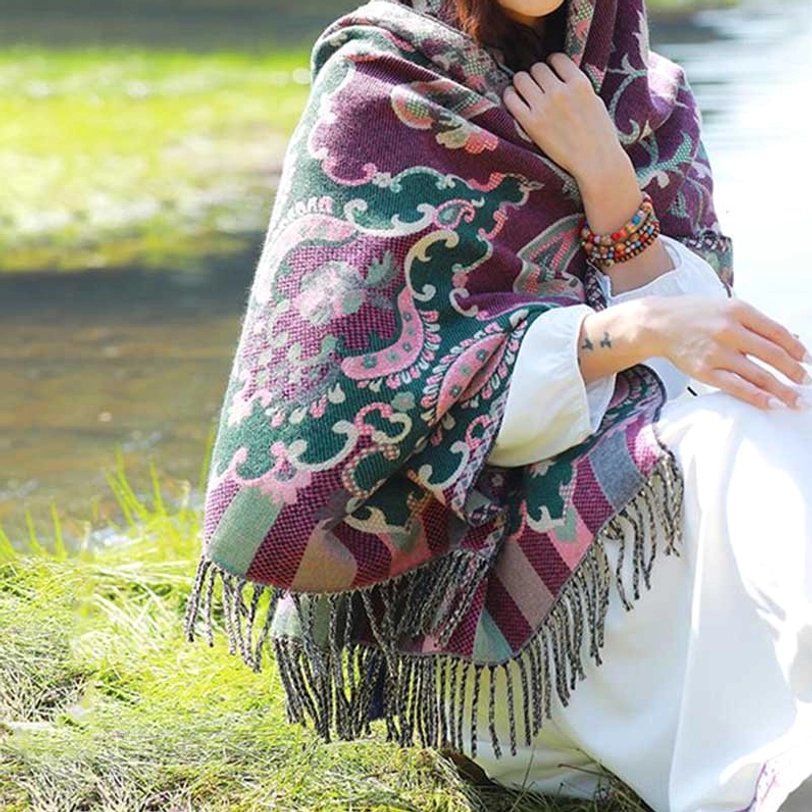 Tibetan vine leaf wrap in dark green botanical pattern with traditional tassel fringe detailing