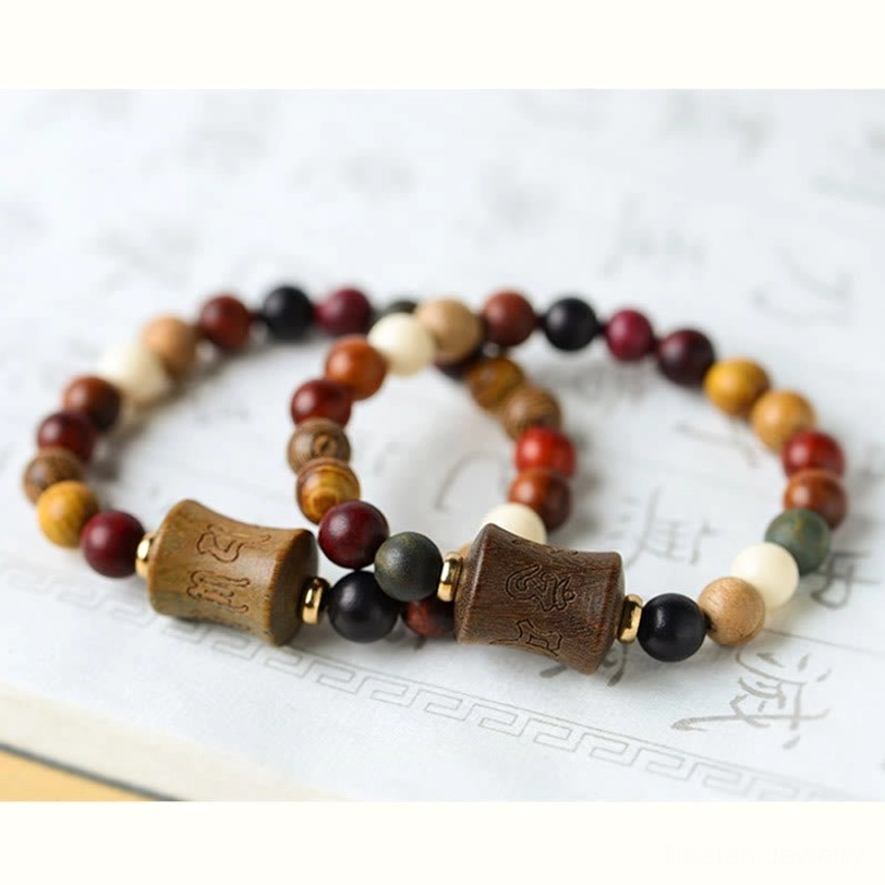 Green sandalwood and multicolor wood beads arranged showing natural material variety and quality of Tibetan bracelet materials