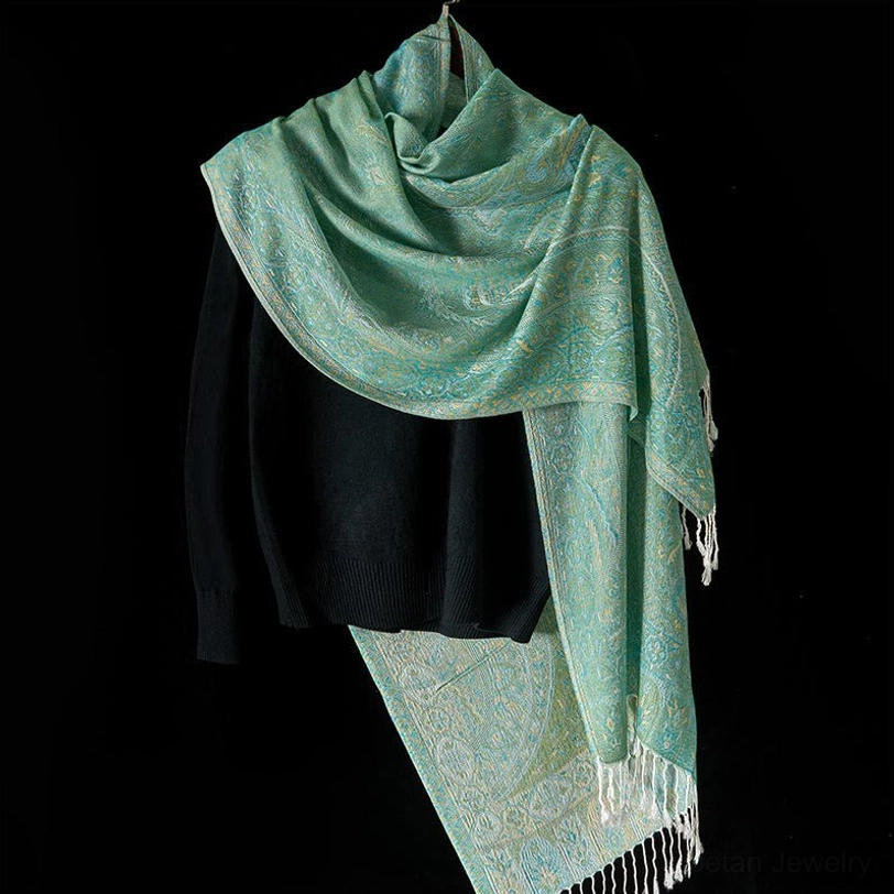 Tibetan handwoven mint green shawl with intricate jacquard texture draped over black knit top, showcasing loose fit and all-over pattern detail