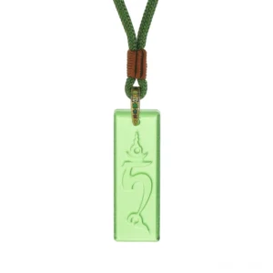 Flat lay view of Green Tara Tibetan protection necklace with braided green cord and decorative knot, rectangular crystal glass pendant