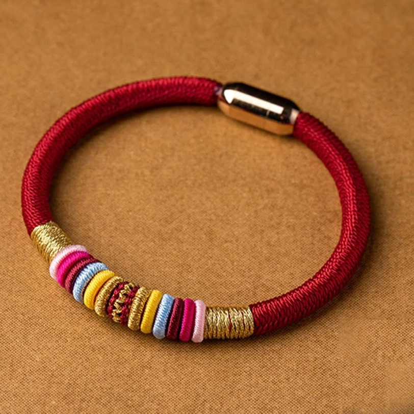 Red braided Tibetan Vajra Knot bracelet with multi-color woven bands and shiny magnetic clasp, front close-up