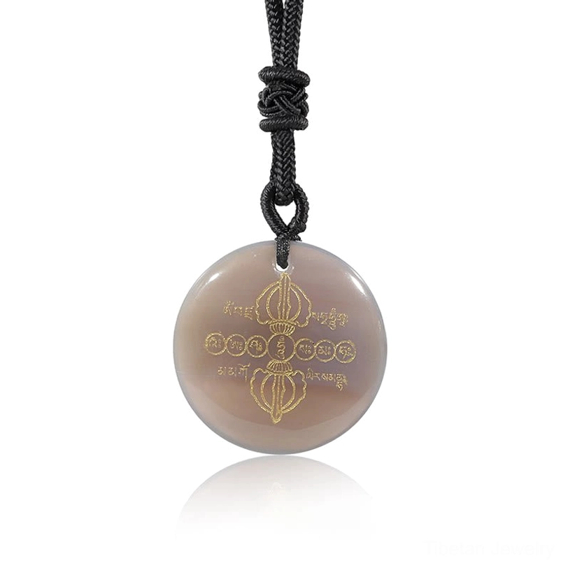 Handmade Vajra Dorje Tibetan necklace pendant with natural gemstone and golden religious symbols