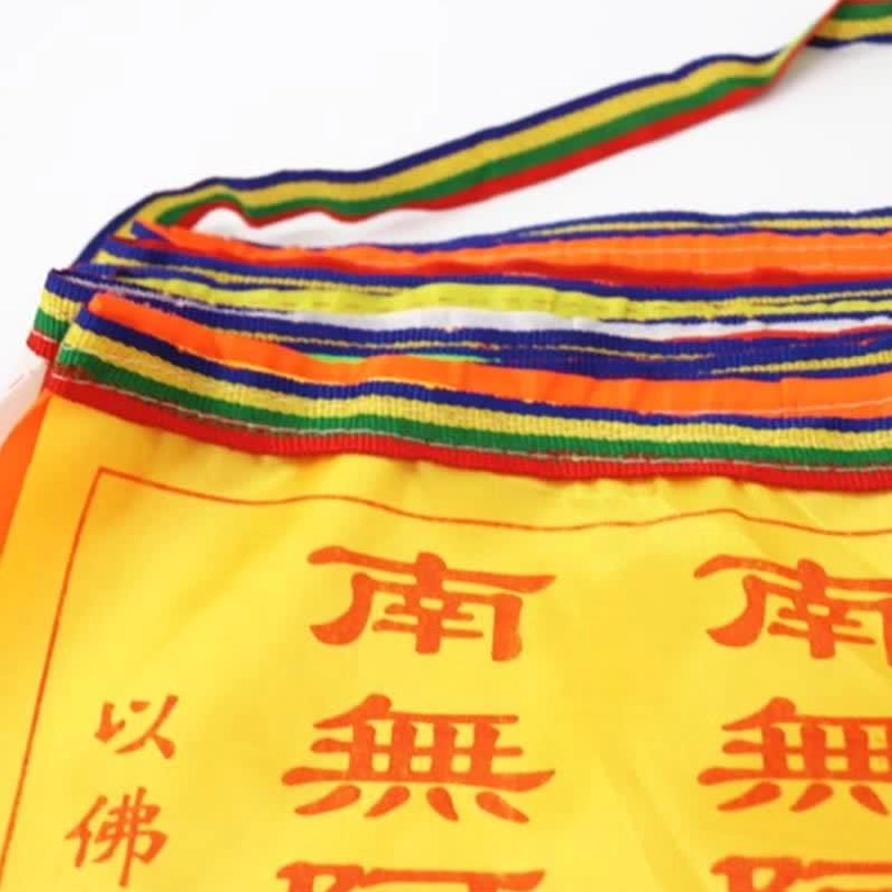 Handprinted Buddhist prayer flags showing intricate mantra details and color sequence