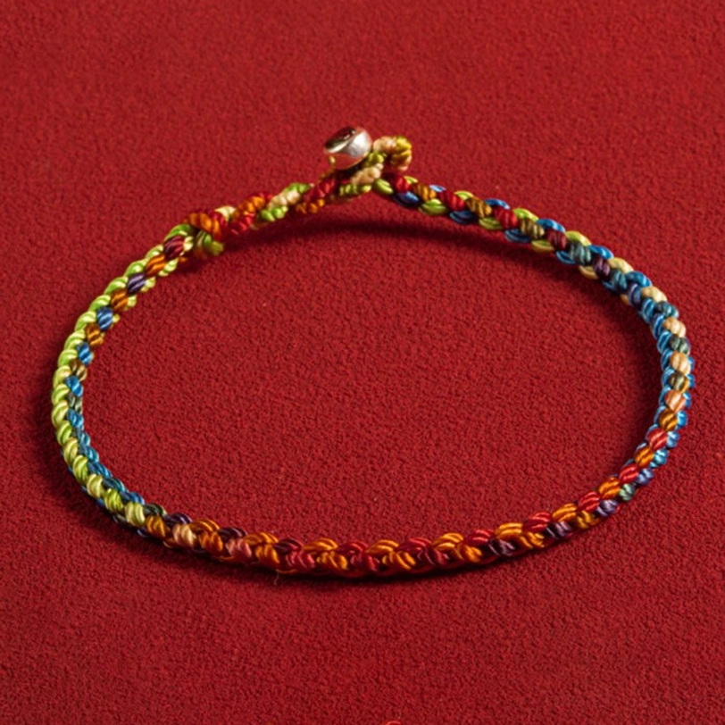 Handwoven Tibetan protection bracelet displaying vibrant multicolor threads and sterling silver clasp