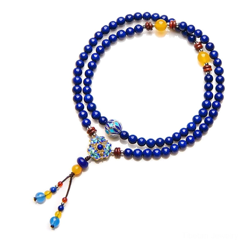 Complete Tibetan Lapis Lazuli Yellow Agate healing bracelet laid flat, featuring blue round beads with yellow and brown accents