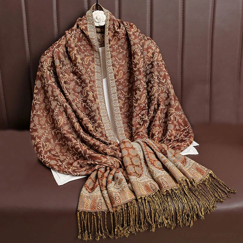Tibetan hooded paisley shawl being worn as decorative wrap showing how artisanal craftsmanship creates unique cultural aesthetic appeal