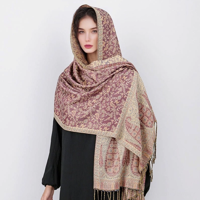 Tibetan hooded paisley shawl being worn outdoors showing practical versatility for travel, yoga practice, and cultural connection