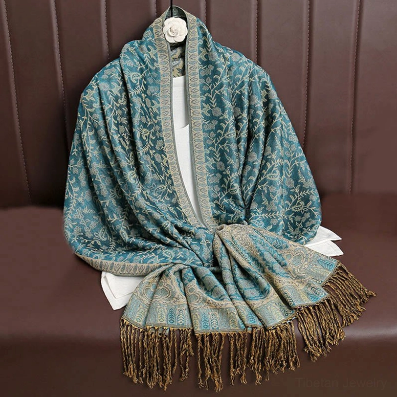 Tibetan hooded paisley shawl in light sea green tone representing the full spectrum of available jewel tone color options