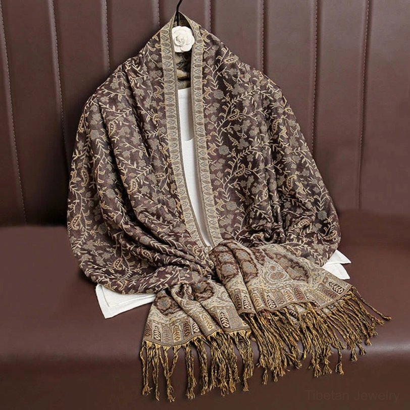 Tibetan hooded paisley shawl worn as protective head covering showing traditional Buddhist-inspired wrapping technique for spiritual practice