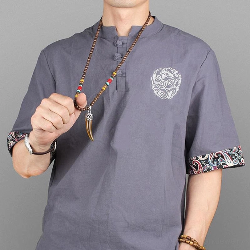 Close-up detail of brown horn pendant with silver ornamental cap - handcrafted amulet design