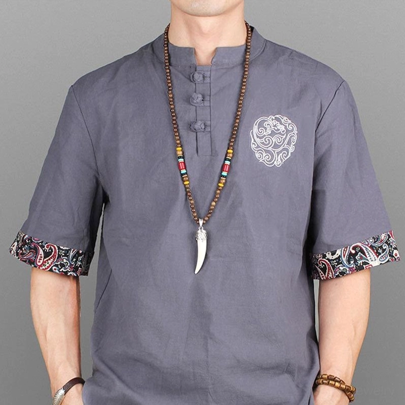 Male model holding Tibetan horn pendant necklace - natural wear positioning and styling reference