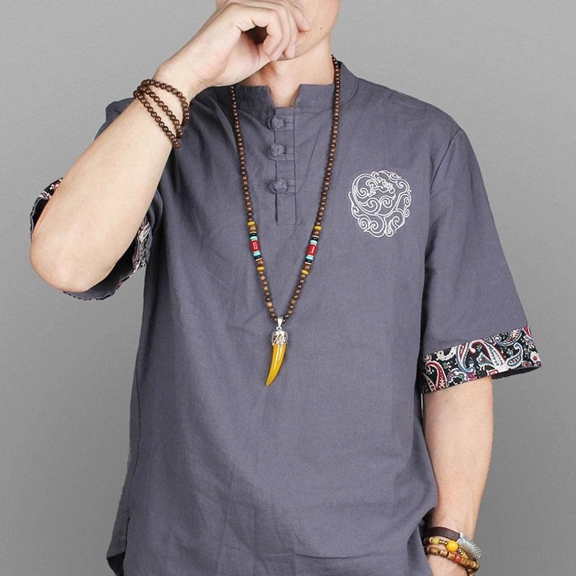 Male model wearing Tibetan horn pendant necklace with ethnic style shirt - lifestyle wear demonstration