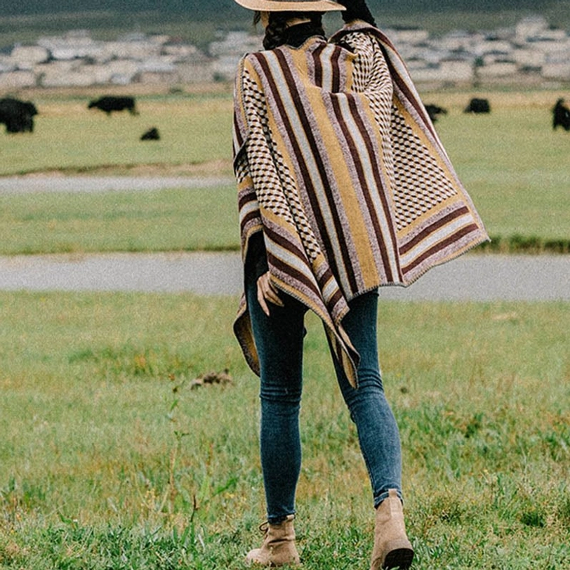 Full rear view of Tibetan houndstooth wrap poncho shawl featuring vertical stripe pattern, styled casually outdoors