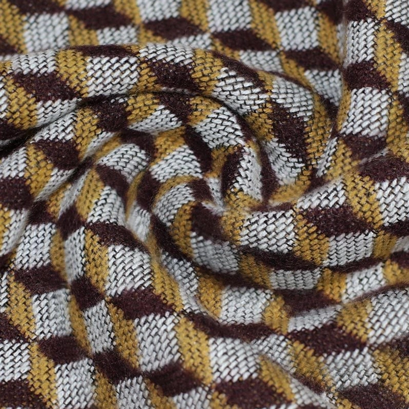 Draped close-up view of Tibetan houndstooth poncho shawl showing 3D pattern texture in warm earthy color palette