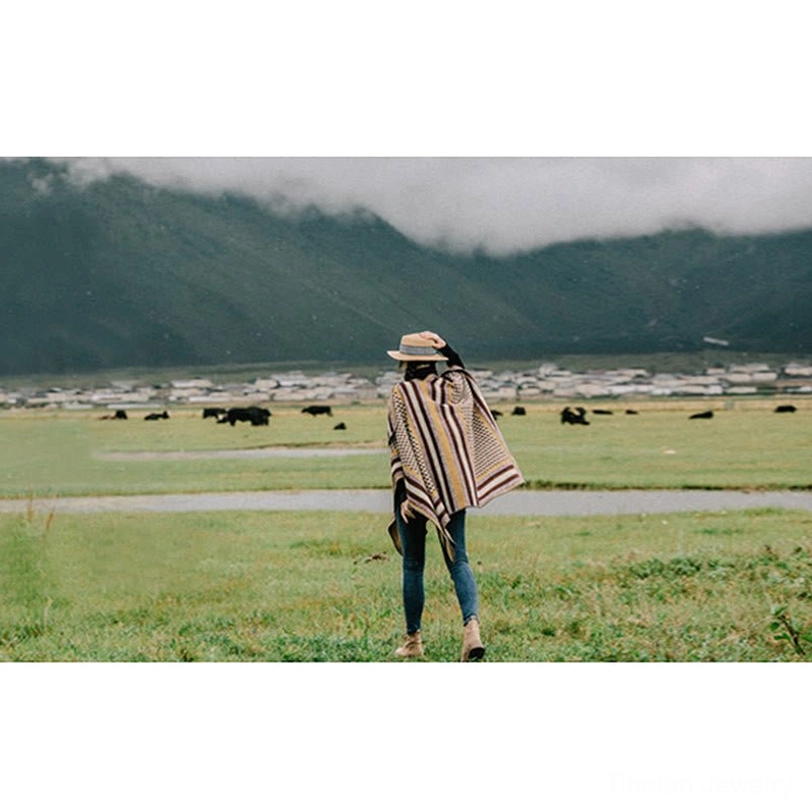 Tibetan houndstooth shawl wrap lifestyle photography in natural setting highlighting comfort and style