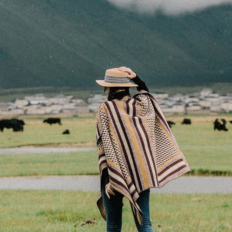 Tibetan houndstooth poncho shawl outdoor portrait showing product with natural lighting and texture