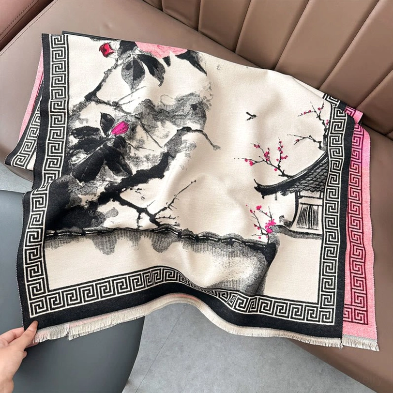 Black and pink Tibetan ink scarf on sofa, monochrome artistic design with black Greek key border and fringed hem detail