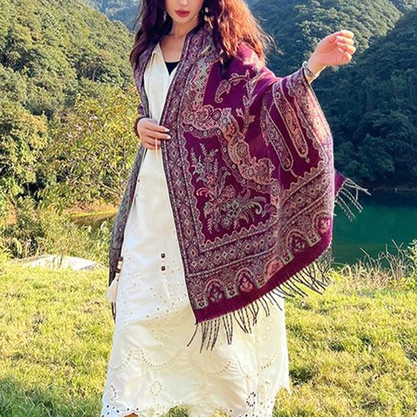 Maroon Tibetan jacquard shawl with detailed woven botanical motifs, draped over shoulders