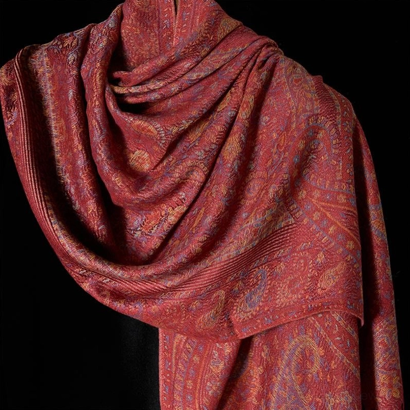 Close-up detail of Tibetan paisley jacquard scarf texture, showing intricate woven pattern