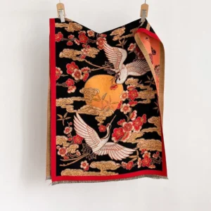 Handwoven Tibetan shawl flat display featuring traditional crane and plum blossom motifs with red border detail
