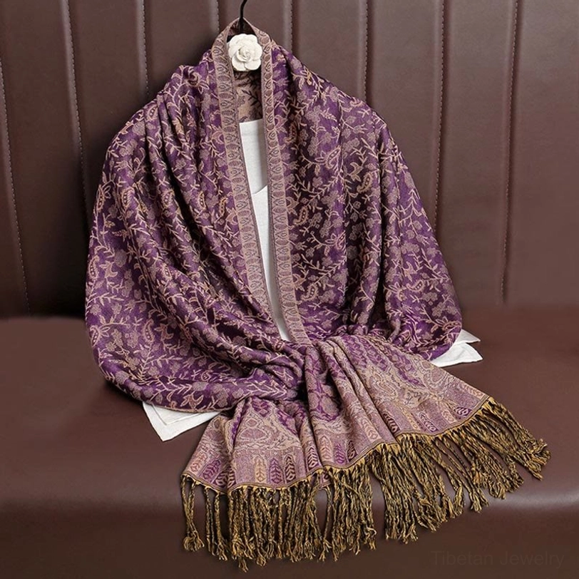 Tibetan jacquard shawl being styled as elegant evening wrap or formal occasion accessory paired with dress or coat