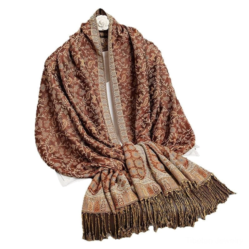 Tibetan jacquard paisley shawl draped over home furniture showing decorator potential as throw blanket or boho interior accent piece