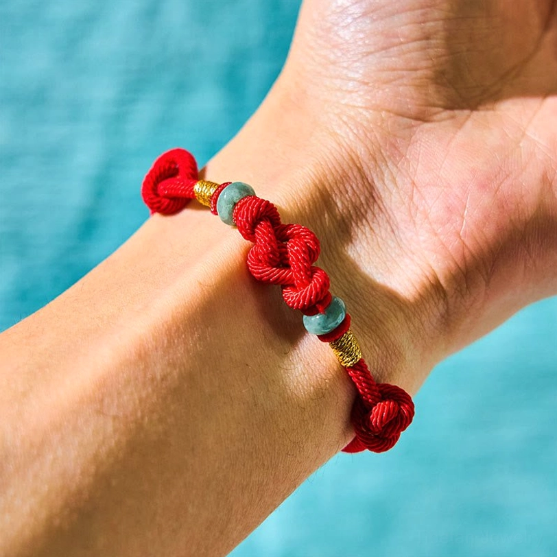 Tibetan fortune knot couple bracelet worn on wrist with jade and gold details