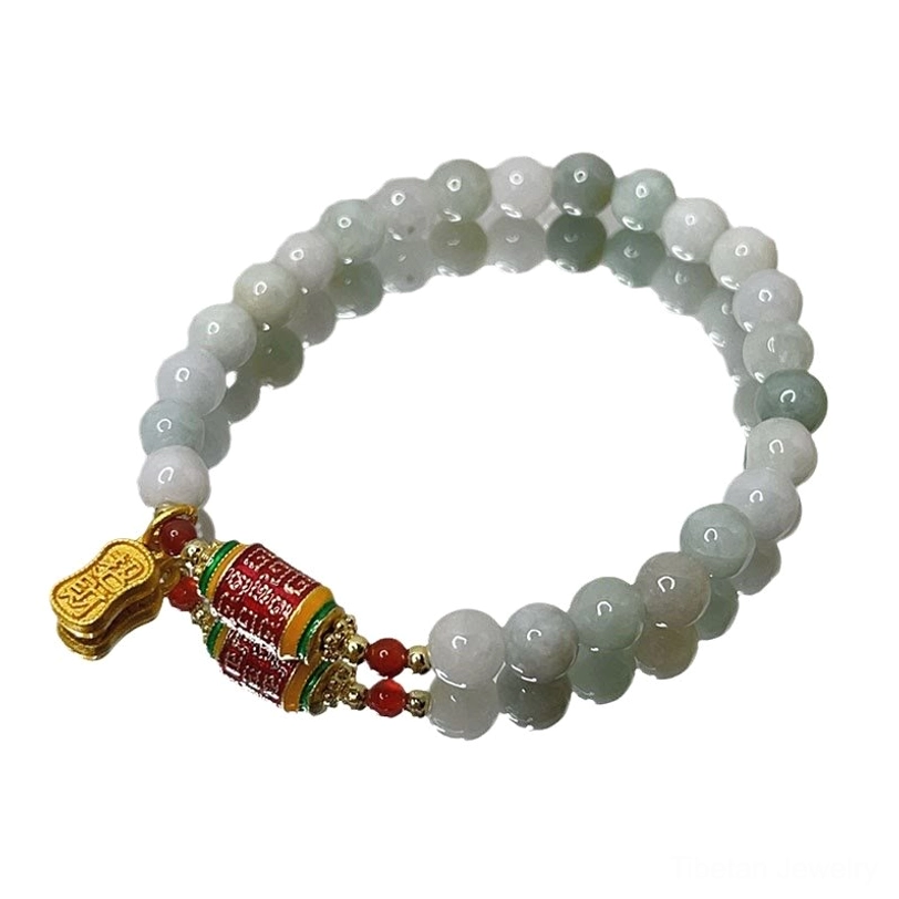 Complete tibetan jade fu prayer wheel bracelet full strand with gradient green beads overhead view