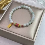 Tibetan jade fu prayer wheel bracelet in satin gift box, light green enamel charms with gold fu pendant