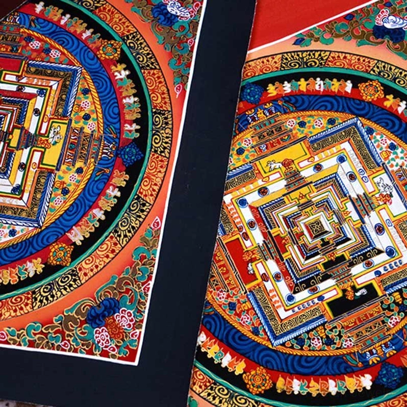 Tibetan Kalachakra Mandala Thangka with intricate multicolored symmetrical patterns and dark border - close-up overhead view
