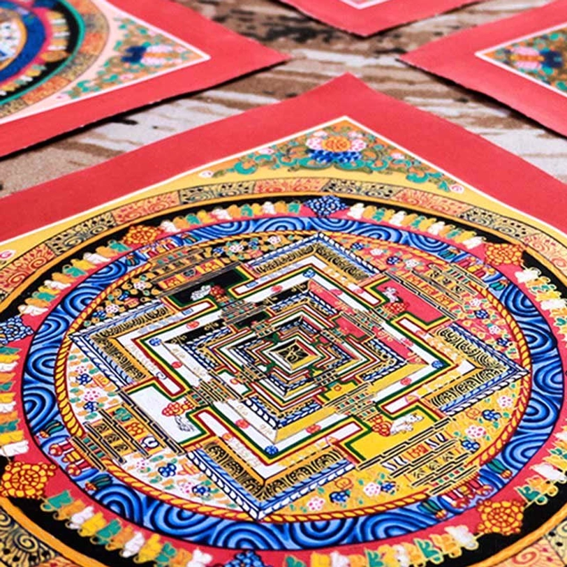 Tibetan Kalachakra Mandala Thangka with bright red, blue, and gold color scheme and highly detailed symmetrical religious art