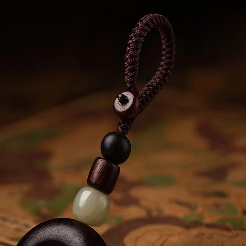 Tibetan keychain with braided cord and wood ring showing traditional construction techniques