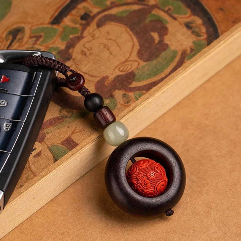 Red sandalwood and cinnabar protection keychain attached to car keys demonstrating practical everyday use