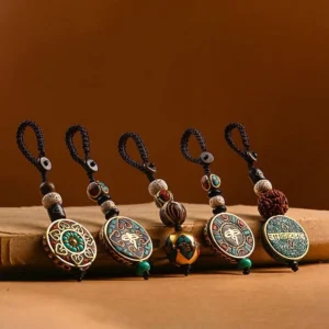 Assorted Tibetan Buddhist keychains with multiple sacred designs including wisdom eye and mandala patterns