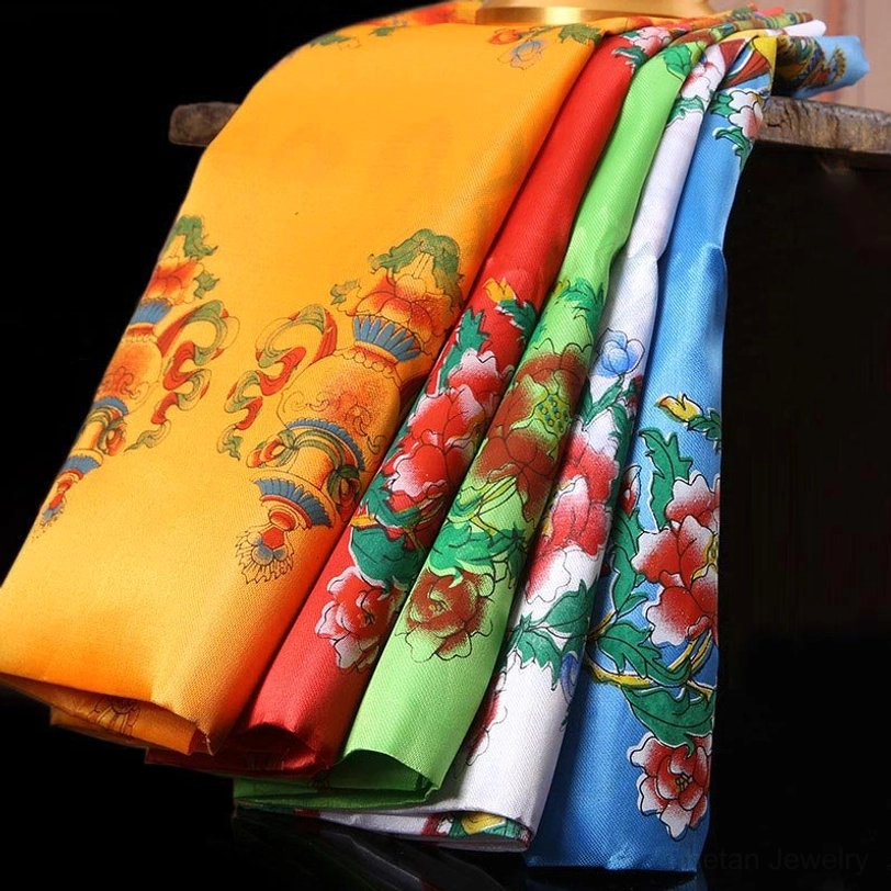 Tibetan khata blessing scarves in five sacred colors - white, yellow, blue, green, and red - displayed with traditional auspicious symbols and printed dharma motifs on glossy satin fabric