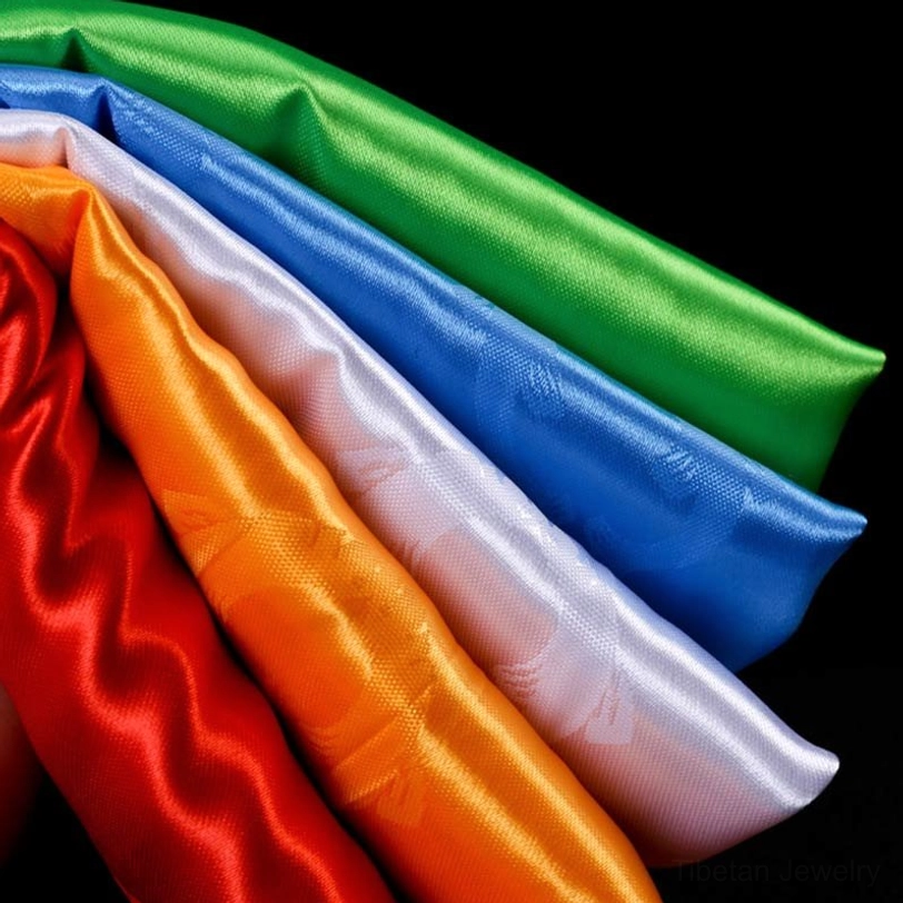 Tibetan khata scarves in five colors representing white purity, yellow wisdom, blue tranquility, green renewal, and red fortune