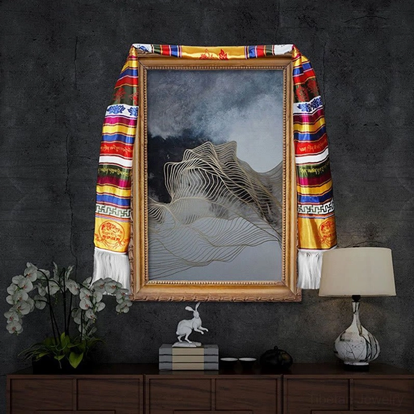 Tibetan khata blessing scarf hung on picture frame for home decor with white tassels and multicolored striped pattern